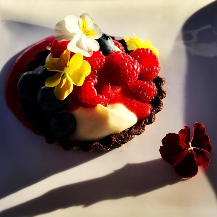 Dessert tart with berries and flowers