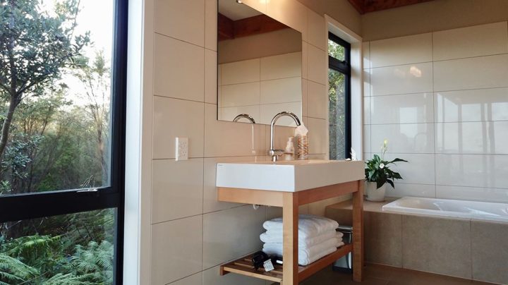 luxury bathroom sink and mirror at Te Kahu